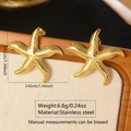 Golden starfish earrings in stainless steel with textured finish on a beige display stand - Gold Textured Starfish Earrings