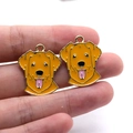 Macro view of gold enamel dog charms featuring detailed golden retriever puppy faces - Golden Retriever