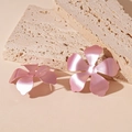 Detailed close-up of matte pink metal flower earrings on a textured stone surface - Silver Earring Post - Pink / Pink