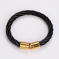 Close-up of black braided steel wire cable bracelet with golden metal end caps - Black with Gold Caps