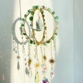 Detail of handmade crystal suncatcher with natural green stone and hanging prisms - Green Aventurine