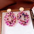 Detail of beaded oval earrings with pink and purple glass beads on a wood box - Gold-Mixed Pink Purple