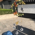 Detail of moon-shaped wind chime with green leaves, orange butterflies and crystal ball - Star Gold Green Leaf - Lapis Lazuli