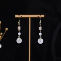 Pale pink butterfly pearl tassel earrings with gold-tone hooks on a black background - E1990-13 (Gold/Pink Pearl/Ping'an Buckle)