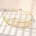 Modern gold iron fruit basket with hollow oval structure and stable metal ball feet - Medium / Gold