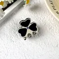 Small clover acetate hair claw clip with black and white contrast and rhinestone detail - Off-white