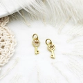 Detailed view of gold mini key pendants with micro-pave rhinestones and heart cutouts - Key