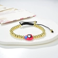 Handmade beaded heart bracelet with evil eye charm on a stylish ceramic display tray - Red Heart