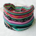 Bohemian style pink and blue striped elastic headband on a soft white plush background - 89