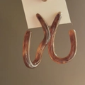 Detailed shot of brown resin hoop earrings with amber texture on a display card - Brown-Twisted Ring (19#)