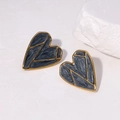Macro shot of 18K gold plated heart stud earrings with dark grey star texture finish - Pearlescent Black