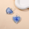 Detail of heart-shaped glass pendants with blue floral patterns on beige background - Blue (Type C)
