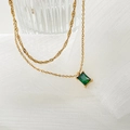 Dettaglio della collana d'oro con un ciondolo rettangolare di pietra verde smeraldo - Zircone Verde
