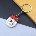 Detail of silver brake disc keychain with red caliper showing metal texture and alloy finish - Brake Disc / Red