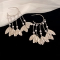 Macro shot of silver sequin fishtail earrings with pearls and long tassels on silk - 92# White Fishtail