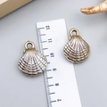 Golden seashell charm with pearl white inlay for DIY necklaces shown with ruler - Electroplated Gold Cream Acrylic Shell 23x19x8mm (23611)