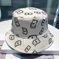 White bucket hat featuring black dollar bill print and a stylish wide brim design - Dollar Sign (White)