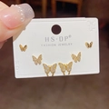 Detailed view of three pairs of gold butterfly stud earrings with sparkling crystals - Butterfly Stud Earrings Set / Gold