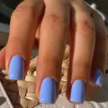 Glossy sky blue medium-long square press-on nails shown on hand with high shine finish - Medium Square / Sapphire Blue