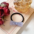Elastic hair tie with purple transparent resin bow charm on vintage book background - Hair Tie / Purple
