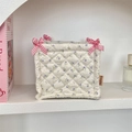 Detail of quilted floral storage basket with pink checkered bows and brand label - Beige Purple Flower