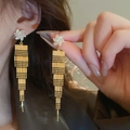 Close-up of model wearing gold long tassel earrings with white flower rhinestones - White Flower Shape Rhinestone Tassel Style (9# Silver Earring Post - Gold)