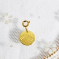 Golden round evil eye pendant with spring buckle on white lace background - Evil Eye Charm Style B