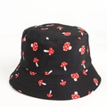 Detail of black cotton bucket hat featuring red and white mushroom pattern print - Mushroom