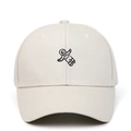 Detailed close-up of astronaut embroidery on a beige cotton baseball cap front - Adjustable / Beige