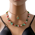 Detailopname van een feestelijke gelaagde kerstketting met emaille bedeltjes op een model - Kerstboom