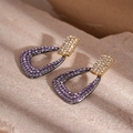 Detail of geometric drop earrings with gold studs and purple rhinestones on a stone texture - Purple Geometric Triangle Drop Earrings (HE22508)