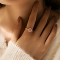Detail of elegant gold ring with round pink gemstone and halo pavé diamond setting - Adjustable Open / Pink (KR0042-1)