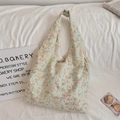 Detail of light green floral tote bag with orange patterns on white textured fabric - Orange Floral