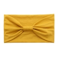 Detail view of the yellow knotted cotton headband with elastic knit fabric texture - Turmeric