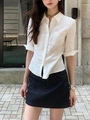 Detail of white linen half-sleeve shirt fabric and button design on model - S / White
