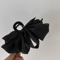Detailed view of a large black satin bow hair claw clip with elegant fabric texture - Large Bowknot / Black