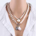 Detail of silver double-layered snake chain with baroque pearl and portrait medallion - Pearl Necklace Silver