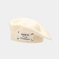 Detail of chunky cream knit beret showing high-quality stitching and fabric patch accent - One Size / Apricot