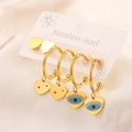 Macro shot of four gold heart earrings with evil eye enamel and star cutouts detail - 2 Pairs Evil Eye Heart Set