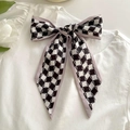 Checkerboard pattern bow hair tie with lavender edges on white textured background - Khaki Border Black White Grid