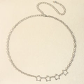 Detailed view of silver star link chain belt with lobster clasp on beige texture - 19366 Silver
