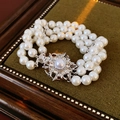 Macro shot of three-strand pearl bracelet with sparkling silver flower diamond clasp - Three-row Bracelet Style / Bracelet-White-Glass Pearl 8mm