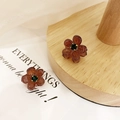 Mini amber brown camellia hair claw clip with a green gemstone center on wood - 119 Coffee Rhinestone (1pc)