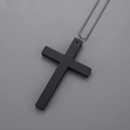 Detail shot of a matte black wooden cross pendant with a metal bead chain necklace - Black