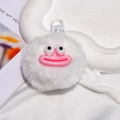 Close-up of white plush monster keychain with fuzzy texture and pink sausage lips - Gate Buckle Style / White
