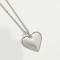 Gros plan sur un pendentif cœur en argent avec nacre et sertissage de pierres - Cœur d'Argent