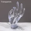 Transparent hand-shaped jewelry display stand for rings and bracelets on marble surface - Clear