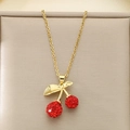 Macro detail of gold cherry pendant necklace featuring pavé red crystals and shiny leaves - Pave Red Rhinestone Double Cherry Style (KN292076-Z)