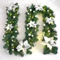 Close-up of 2.7m Christmas garland with white poinsettia, silver baubles and warm LED lights - Premium Pre-lit Style / Silver