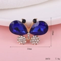 Macro shot of 33mm x 24mm gold butterfly charm with blue crystals and clear rhinestones - D970 Crystal Butterfly (Royal Blue)